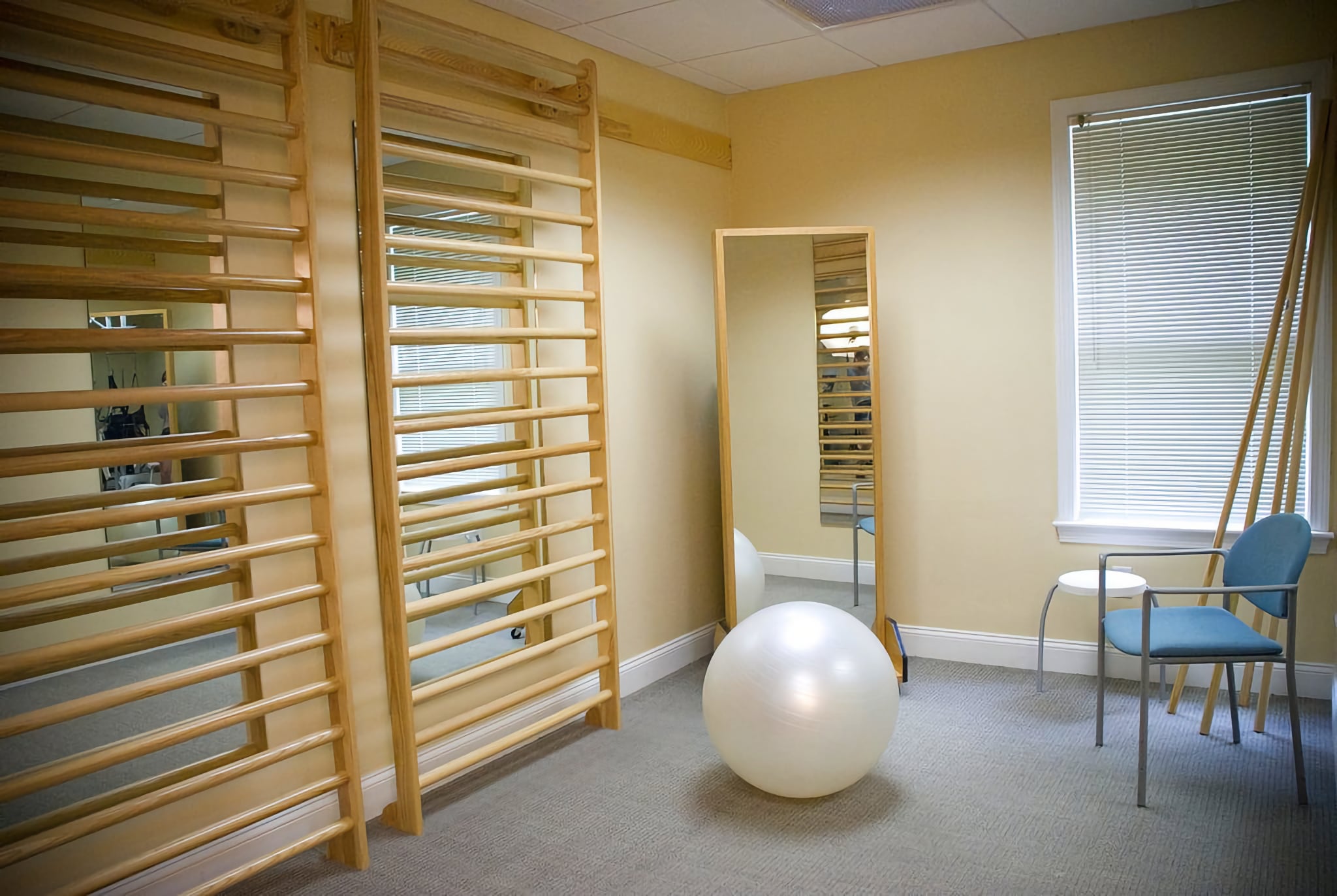 Chiropractic patient room with mirrors and ball.