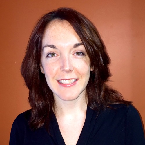 A professional headshot of Amy, a staff member, smiling warmly with dark hair against an orange background.